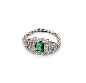 An Art Deco emerald and diamond chain work ring