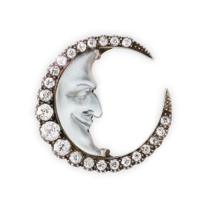 A carved moonstone and diamond brooch