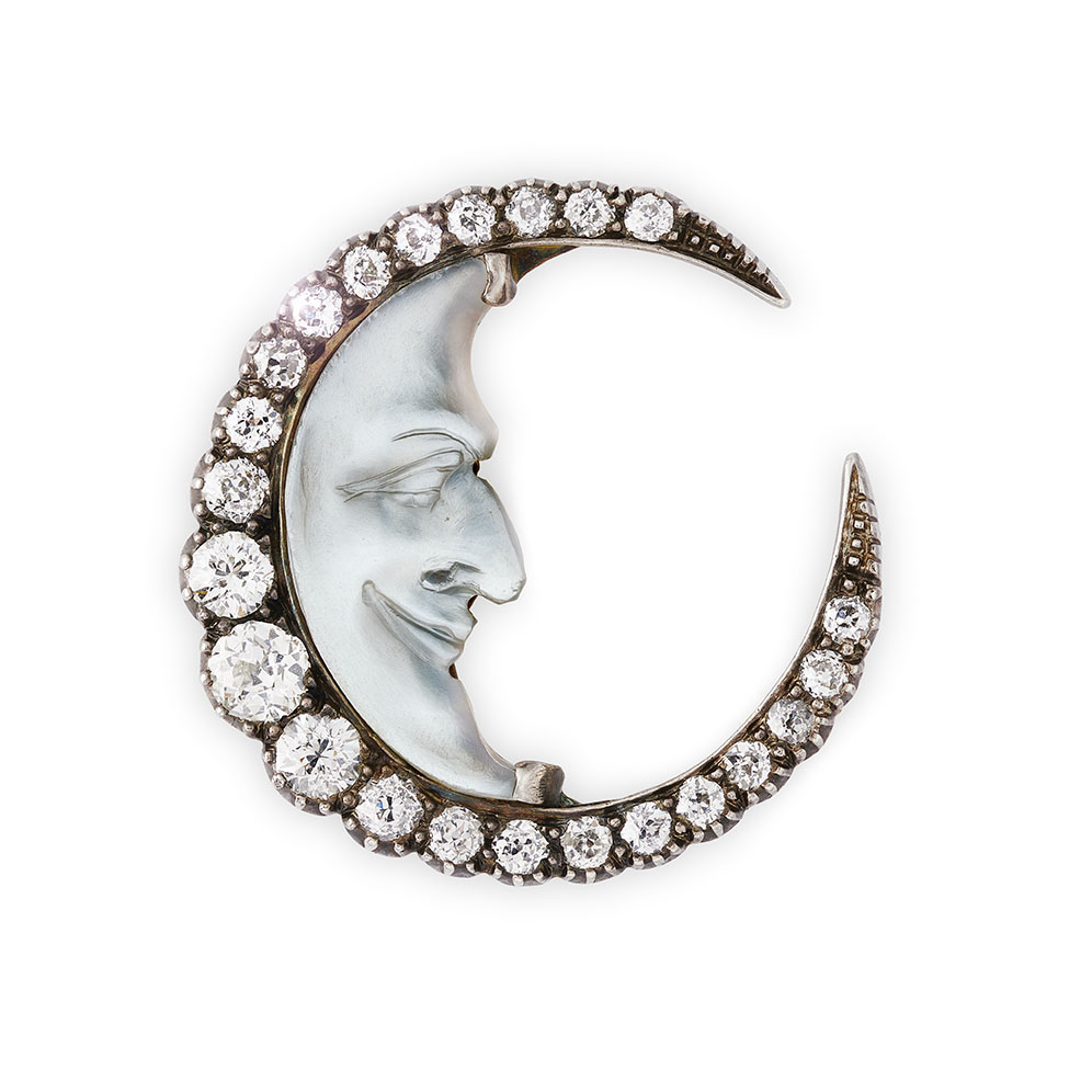 A carved moonstone and diamond brooch