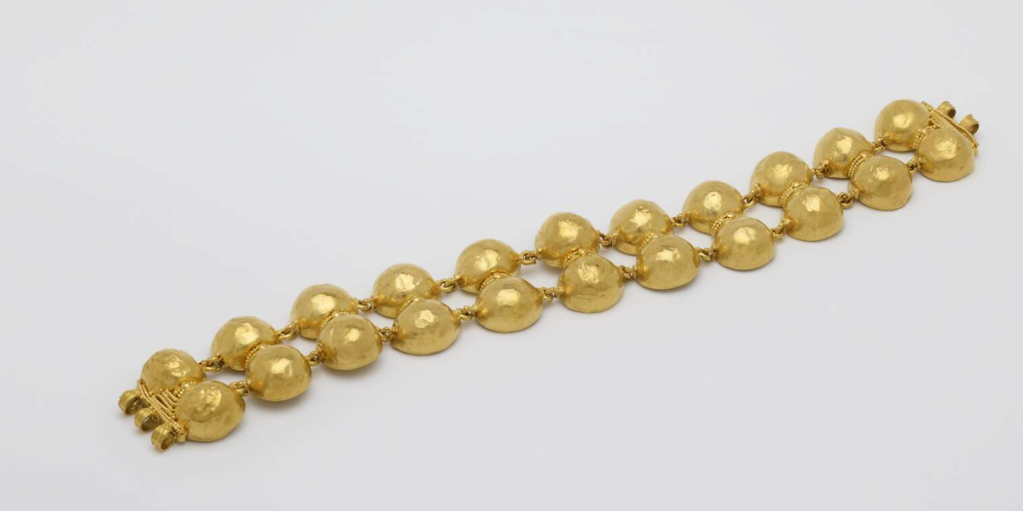 A gold bracelet by Phillips Brothers